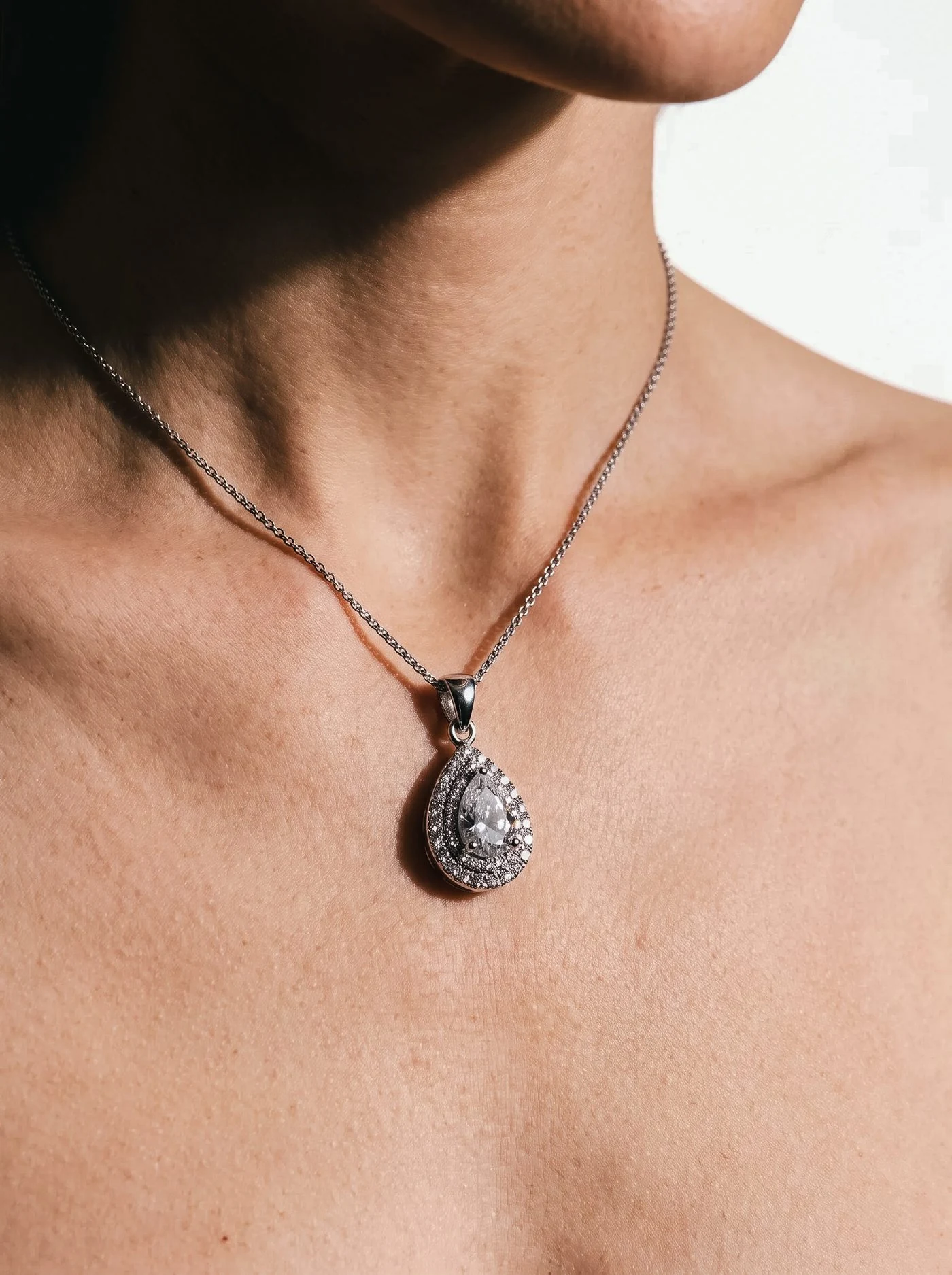 Halo Pendant, No. 005, a pear diamond on a fine chain, worn