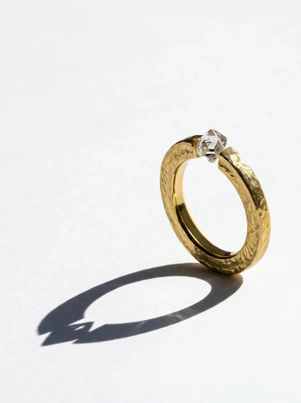 Rough Ring II, No. 010, the hammered gold band standing, the rough diamond held between its two ends